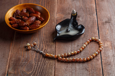 There are smoking date incense and Ramadan rosary on the table. horizontal photoの写真素材