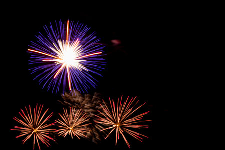 Purple and gold sparks of fireworks on the black sky. Horizontal photo.の写真素材