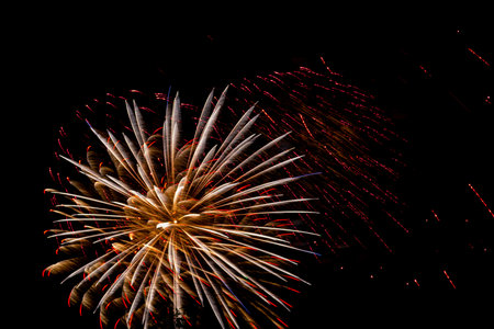 Pink and orange sparks of fireworks on the black sky. Horizontal photo.の写真素材