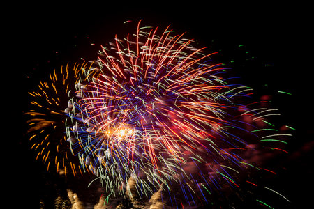 Pink and orange sparks of fireworks on the black sky. Horizontal photo.の写真素材