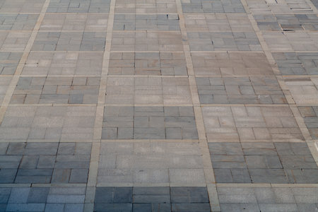 The pedestrian sidewalk, the square is paved with slabs in a checkerboard pattern. Horizontal photo.の写真素材