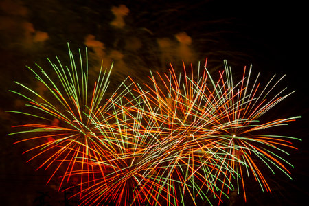 Multicolored Red Green Gold Bright Fireworks Sparks on Black Sky. Horizontal Photo.の写真素材