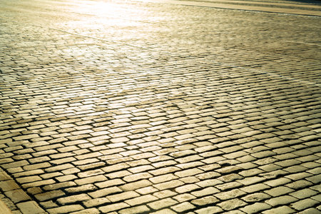 Sidewalk pedestrian square paved with cobblestone texture. Horizontal photo.の写真素材