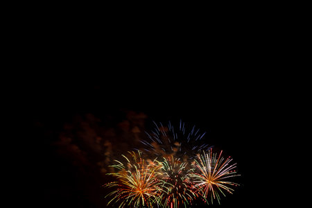 Golden colorful bright sparks of fireworks on the black sky. Horizontal photo.の写真素材