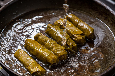 Dolma with beef is fried in a frying pan with oil. Horizontal photo.の写真素材