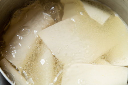 boiled tofu in boiling water in pot, closeup of photoの写真素材