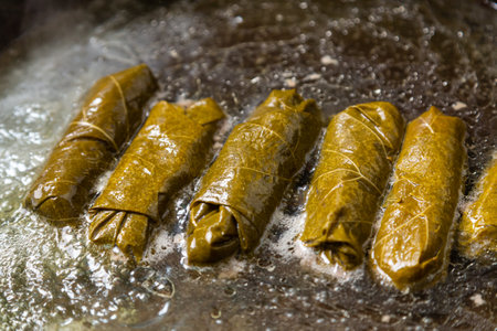 Dolma grape with beef in a frying pan with oil stewed in water. Horizontal photo.