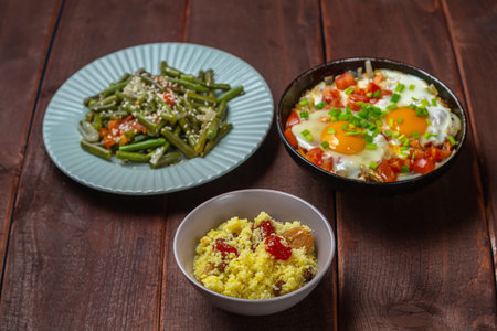 Jewish food tzimmes, chelnt, shakshuka and couscous with dried fruits for the holiday. Horizontal photo.の写真素材