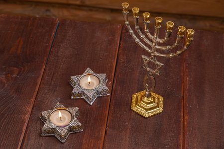 Menorah lit candles in candlesticks with the Star of David on the eve of Shabbat. Horizontal photo.の写真素材
