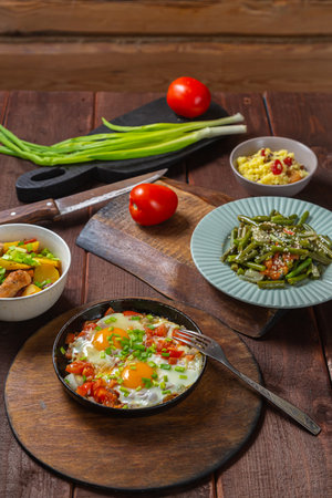 Set table, Jewish food, tzimmes, chelnt, shakshuka and couscous with dried fruits. Vertical photo.の写真素材