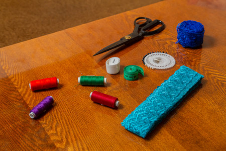 Sewing and knitting threads, knitting needles, measuring tape, needles and scissors on the table in the room Horizontal photo.の写真素材