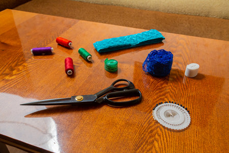 Sewing and knitting threads, measuring tape and scissors on the table in the room Horizontal photo.の写真素材