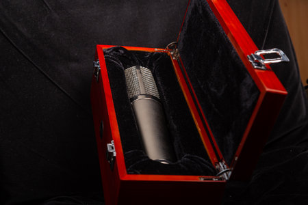 Professional silver studio microphone in a red box with locks. Horizontal photo.の写真素材