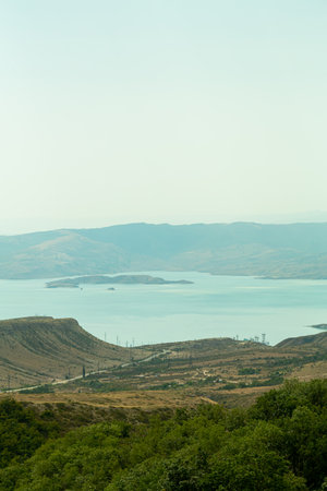 Mountain lake light turquoise water on a sunny day. Vertical photo.