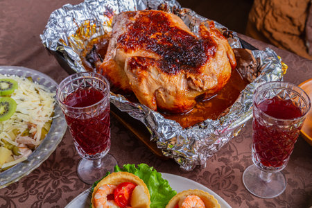 Whole roasted turkey on a festive table with other dishesの写真素材