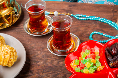 A festive table set with traditional chakm dishes and sweets during Ramadan. Horizontal photo.