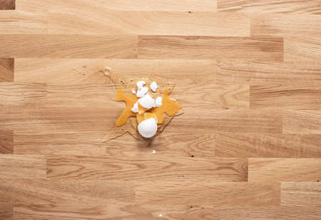 Broken egg on a wooden table