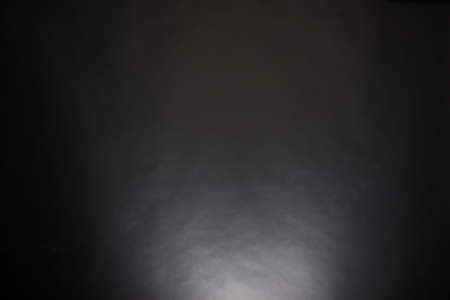 black background paper lit by a single lightの写真素材