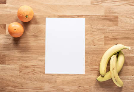 Oranges and bananas on a wooden table
