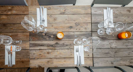 table set on dining table with wooden chairs.の写真素材