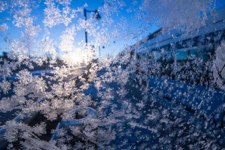 Ice crystals on a window backlit by the sun