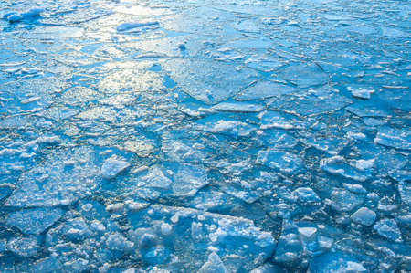 The reflection of the sun in ice formed in a river