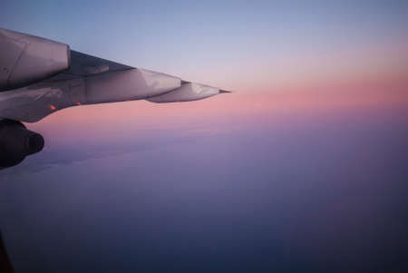 The wing of an airplane and a beautiful sunset.の写真素材