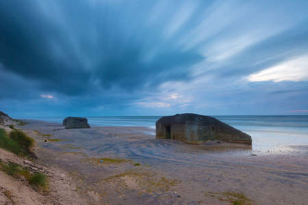 Long exposure of old bunker fortifications on a sandy beach.の写真素材