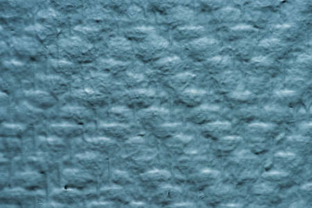 Details of a woven, blue, painted wall.