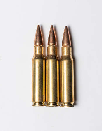Three rifle bullets on white background.