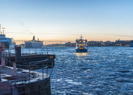 Gothenburg, Sweden - February 8 2011: Ferry Älv-Snabben 3 arriving at Rosenlund in the evening.のeditorial素材