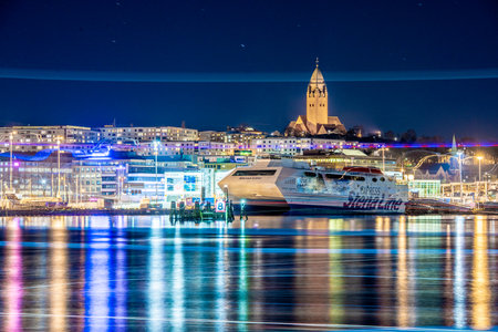 Gothenburg, Sweden - March 11 2019: The catamaran ferry Stena Carisma laid up in the harbour. Masthuggskyrkan in the backgroud.のeditorial素材