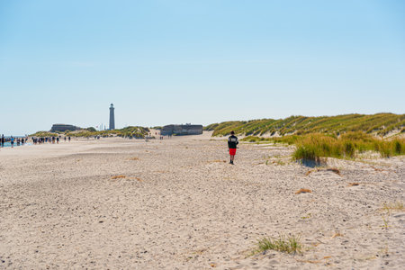 Skagen, Denmark - July 10 2019: The beaches of Grenen with the Grå Fyr in the background.のeditorial素材