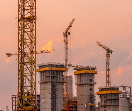 Yellow cranes and elevator shafts under construction..の写真素材