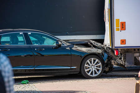 Black car that has crashed into the back of a white lorry..の写真素材