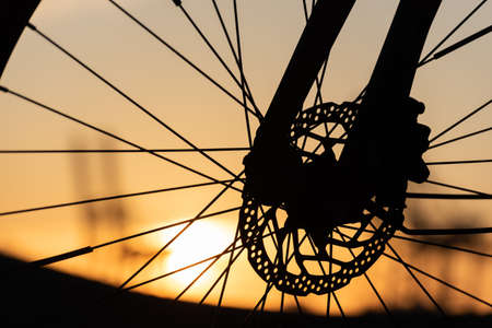 Profile of a bicycle wheel with disc brakes at sunset..の写真素材