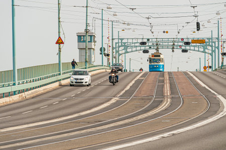 Gothenburg , Sweden - April 10 2011: Tram, cars and motorcycles on the GÃ¶ta Ãlv bridge.のeditorial素材