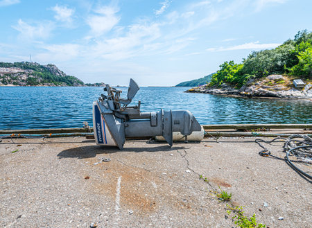 Lindesnes, Norway - June 09 2018: Old Evinrude outboard motor on the docks.のeditorial素材