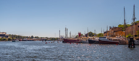 Stockholm, Sweden - july 3 2018: Ols ships moored at Skeppsholmen. GrÃ¶na lund and Vasamuseet in the background.のeditorial素材