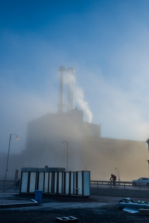 Gothenburg, Sweden,  - February 24 2016: Sun shining through early morning fog at Rosenlund power plant.のeditorial素材