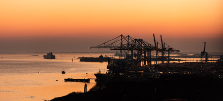 Gothenburg, Sweden â March 26 2020: Skandiahamnen at sunset. ships, containers and ship to shore cranes at work.のeditorial素材