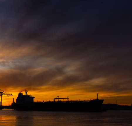 Silhouette of an oil tanker at sunset.の写真素材