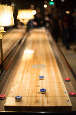 Playing the game of shuffleboard..