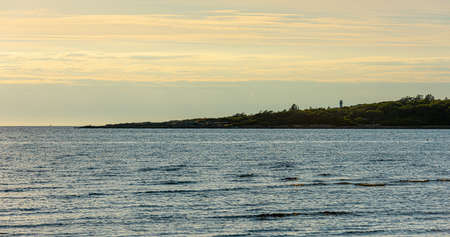 Silhouette of a small peninsula with a lighthouse