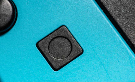 A black square button on a blue hand controller