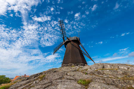 Wide angle photo of an old traditional wooden flour windmill.