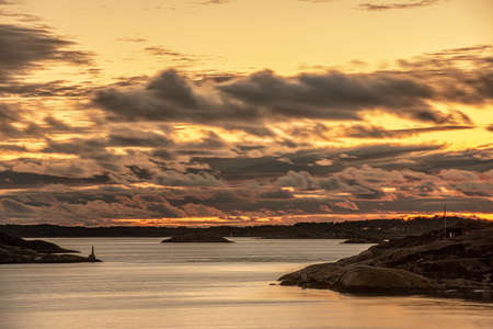Magical orange golden sunset over an archipelagoの写真素材