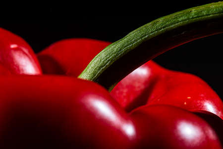 Detail of a red pepper, capsicum, on black backgroundの写真素材