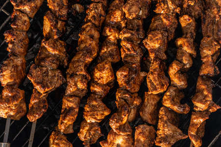 Chicken grilled on skewers on a barbeque