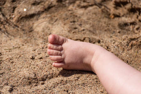 a baby foot in the sand